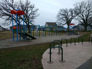 Jones Park playground equipment with houses in background