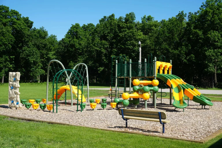 Town hall park playground surrounded by grass and trees