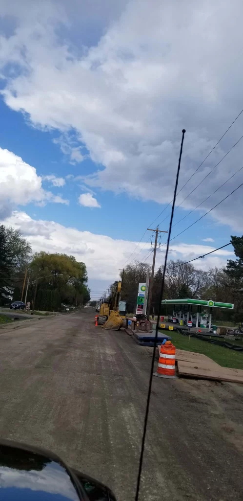 Dirt road under construction next to gas station