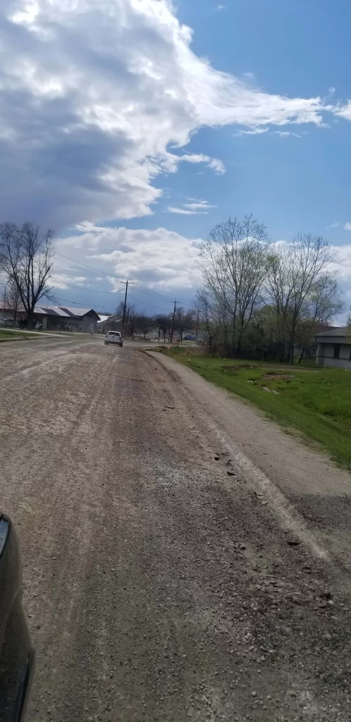 Dirt road in residential area from car perspective
