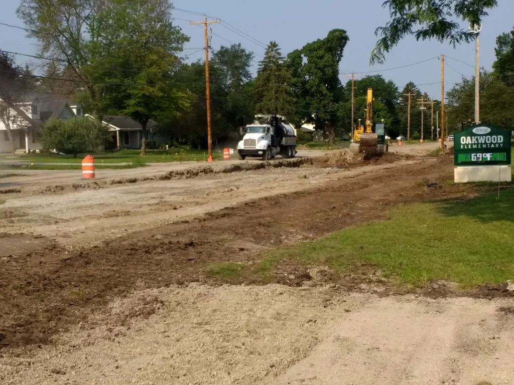A dirt roadway under construction next to Oakwood Elementary