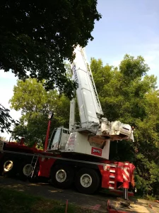 A piece of large construction equipment near trees