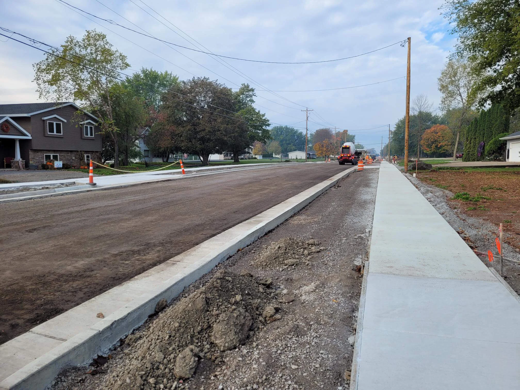 Road and sidewalk construction is underway in a residential neighborhood in the Town of Algoma