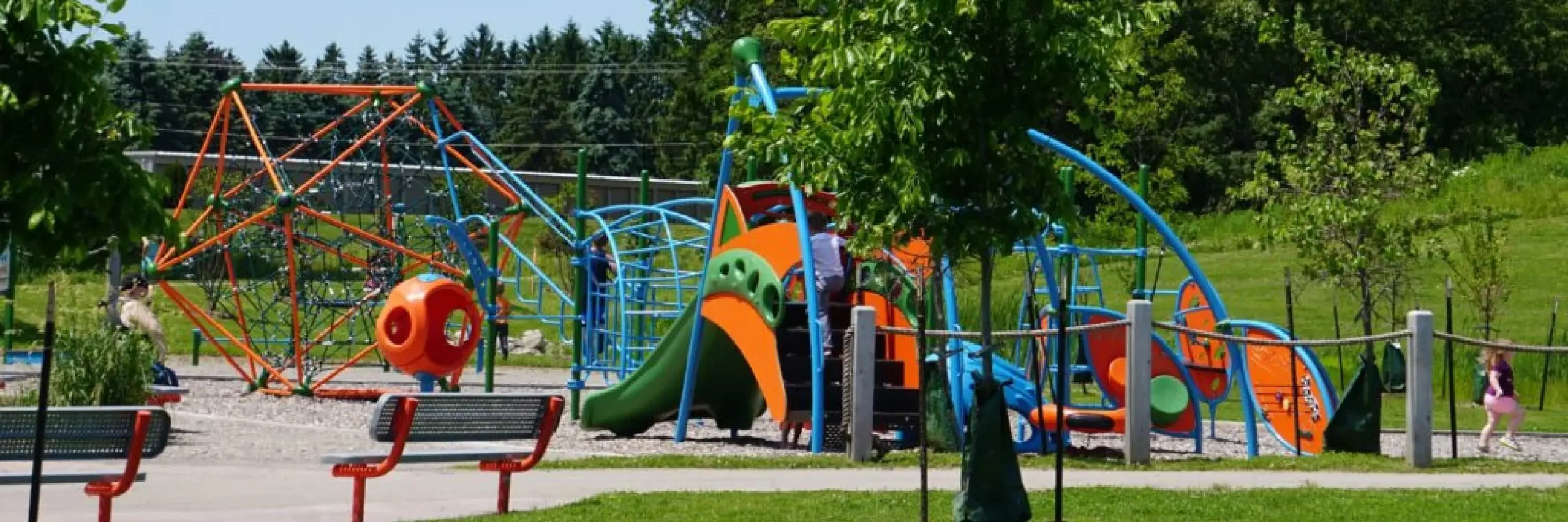 Multiple pieces of playground equipment at a park in the Town of Algoma